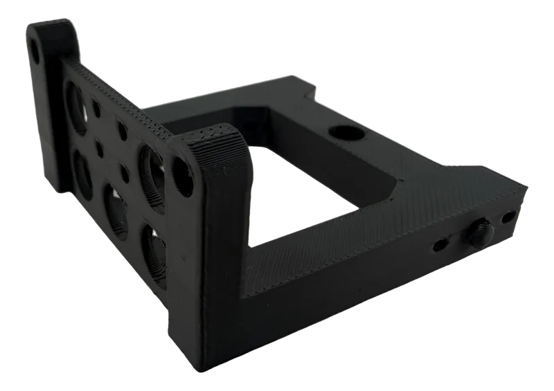 Black ABS FDM 3D printed mounting bracket with lightening holes showing clean layer lines and functional features